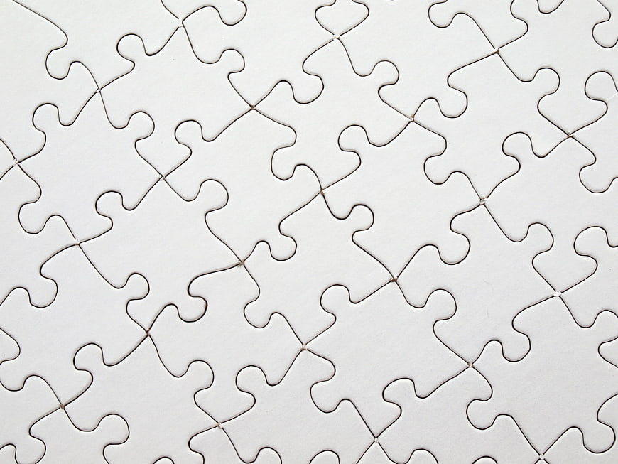 White jigsaw puzzle pieces background pattern