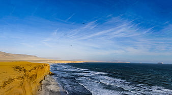 Desert cliffs meeting the ocean in a dramatic coastal landscape
