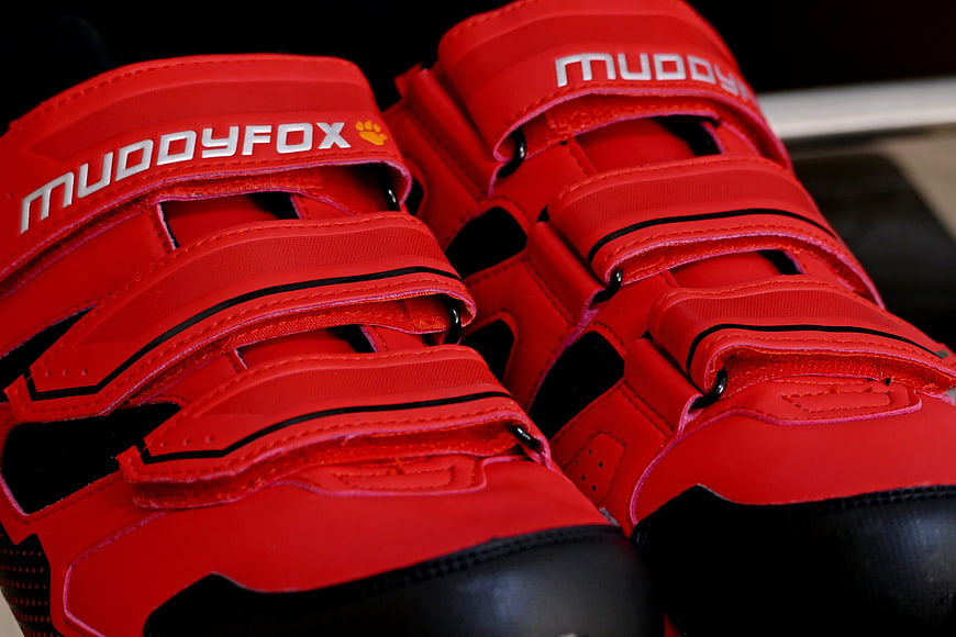 Close-up of red Muddyfox cycling shoes with velcro straps