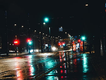 Wet City Street at Night with Neon Reflections