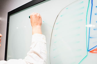Hand drawing diagram on whiteboard in office