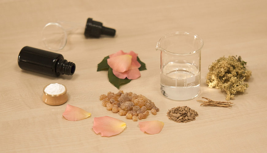 Natural perfume ingredients and essential oils on wooden table