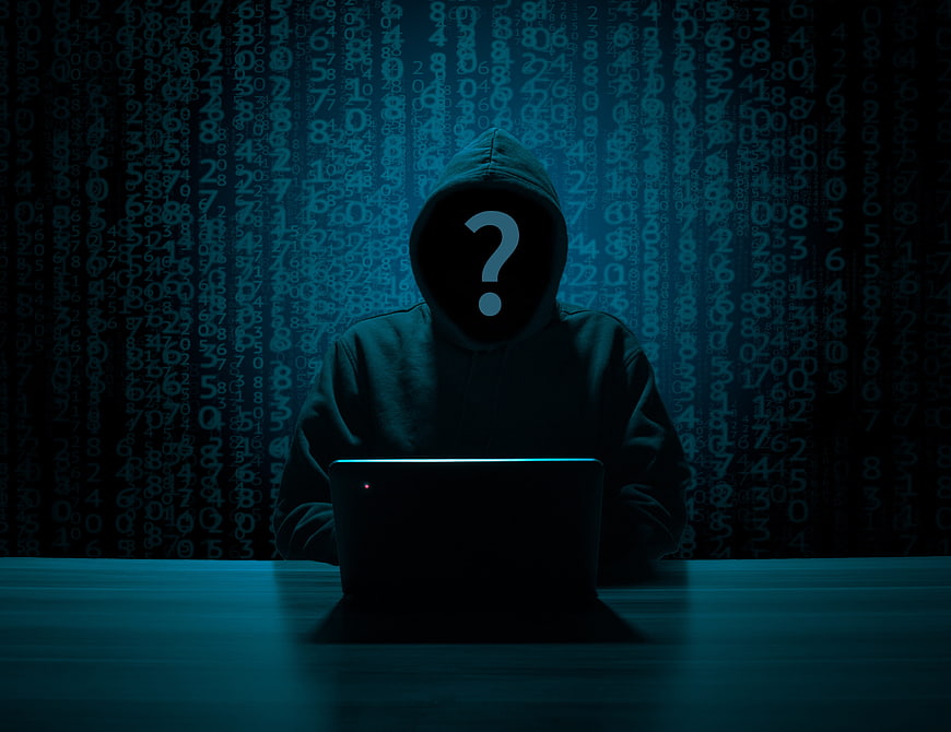 Anonymous Hacker Silhouette with Question Mark on Laptop