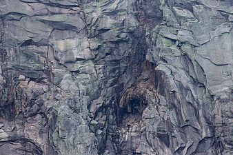Close-up texture of rugged gray rock cliff face