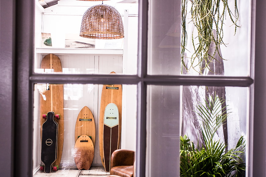 Skateboards and surfboards displayed in a shop window