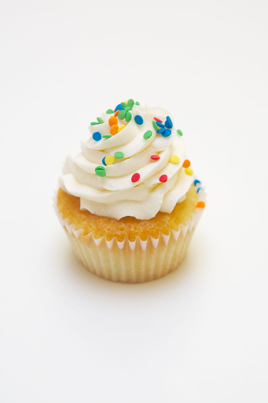 Vanilla Cupcake with White Frosting and Colorful Sprinkles