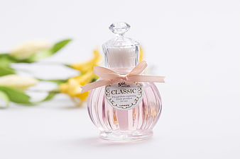 Pink Glass Car Perfume Bottle With Ribbon And Floral Background