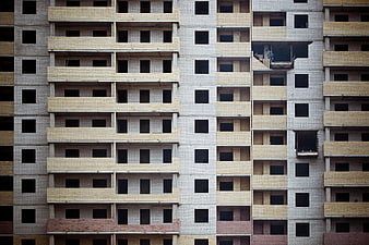 Facade of unfinished apartment building with brick patterns