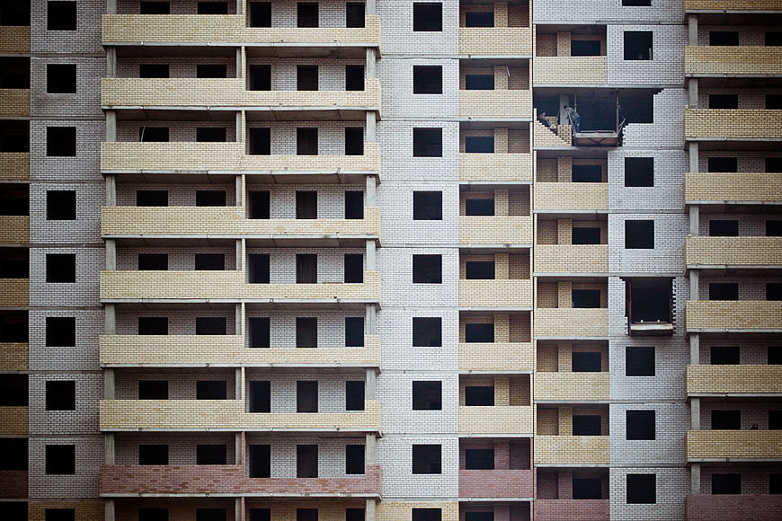 Facade of unfinished apartment building with brick patterns