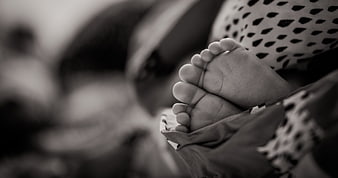 Close-up of baby feet in black and white