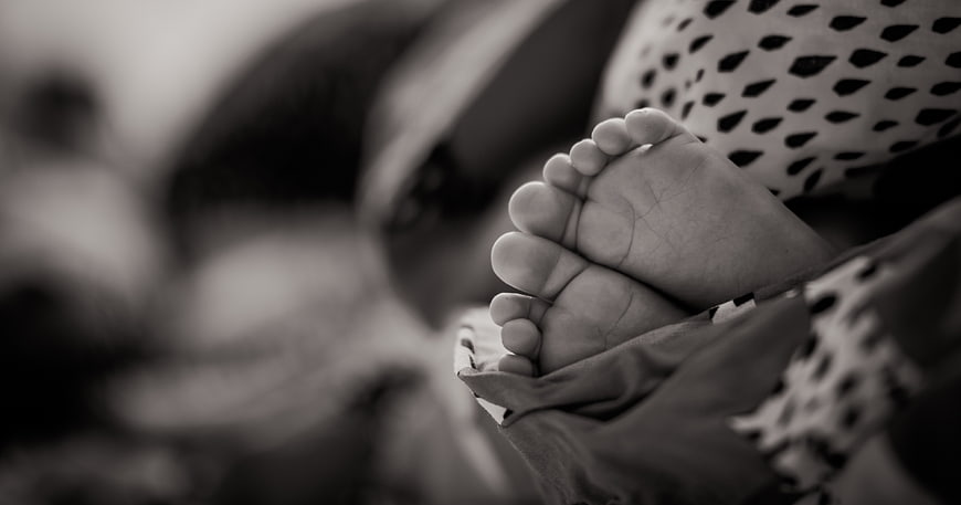 Close-up of baby feet in black and white