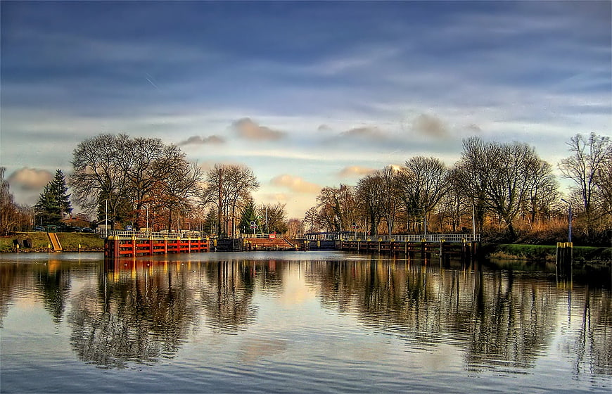 Scenic Canal Lock in Fürstenwalde, Germany, with Autumn Trees and Water Reflections