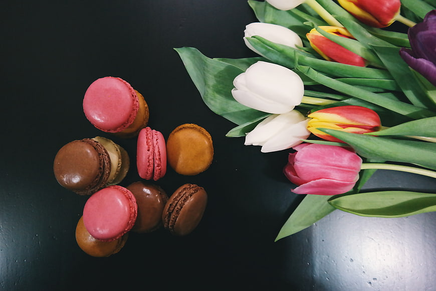 Colorful Macarons and Tulips on Dark Background