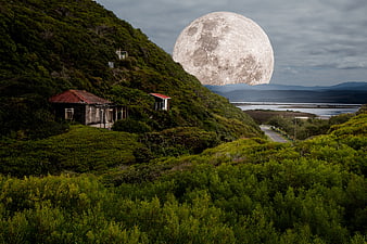 Giant Supermoon Rising Over Coastal Hillside Landscape