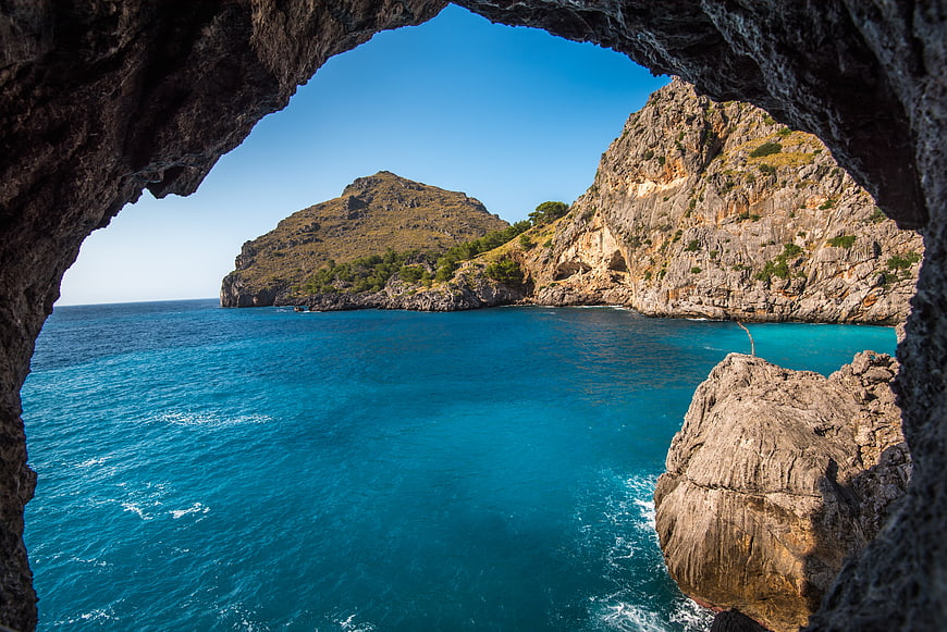 View of Turquoise Sea Through Coastal Cave Arch