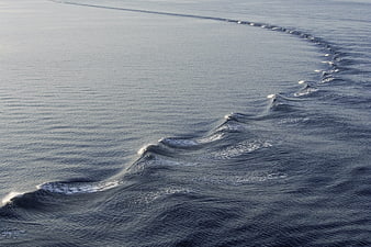 Aerial view of a long line of breaking ocean waves