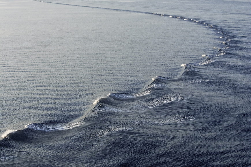Aerial view of a long line of breaking ocean waves