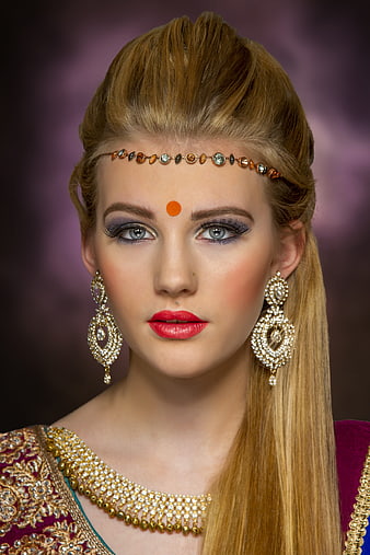 Portrait of a woman in traditional Indian bridal jewelry and makeup