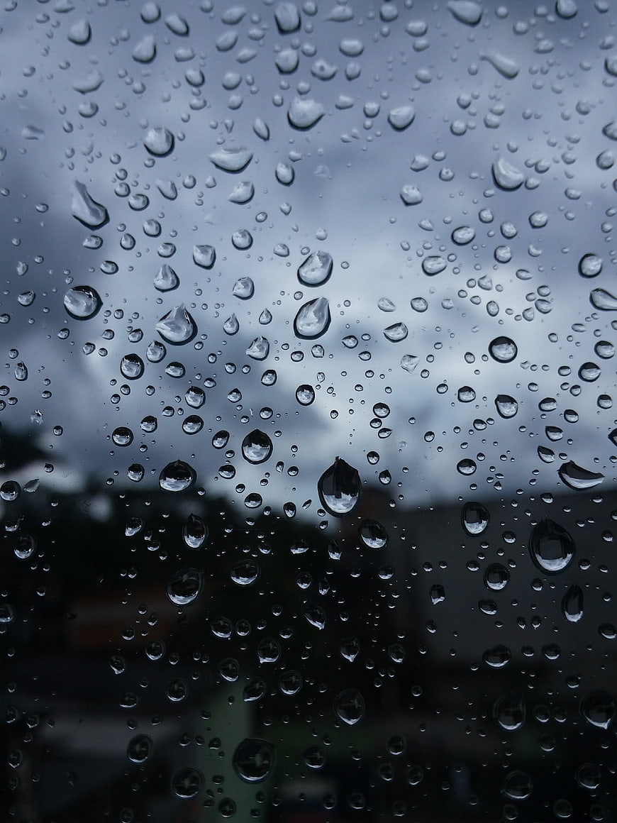 Raindrops on Window Glass with Blurred Background
