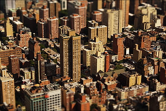 Aerial tilt-shift view of dense urban cityscape with skyscrapers