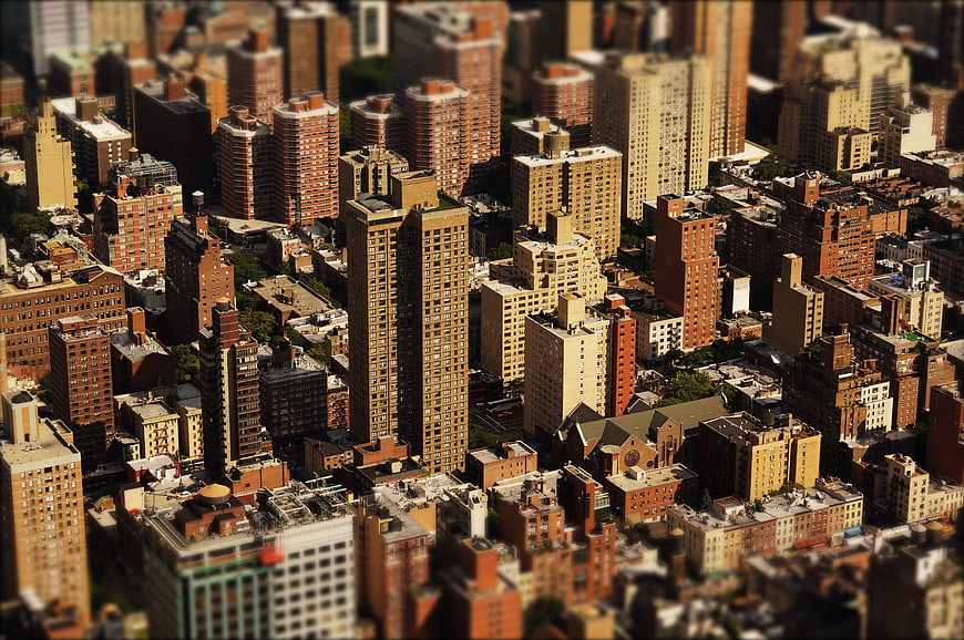 Aerial tilt-shift view of dense urban cityscape with skyscrapers