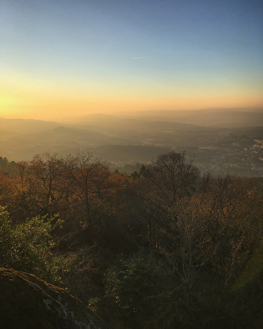 Golden Sunrise Over Hazy Mountain Valley with Forest