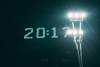 Digital Clock Displaying 20:17 Under Stadium Floodlights at Night