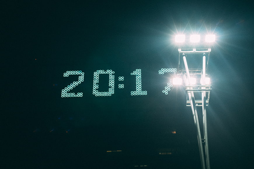 Digital Clock Displaying 20:17 Under Stadium Floodlights at Night