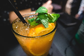Refreshing orange cocktail with mint garnish in a glass