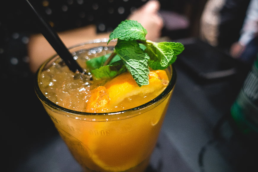 Refreshing orange cocktail with mint garnish in a glass