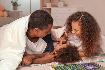 Happy African American Family Reading Bedtime Story Together