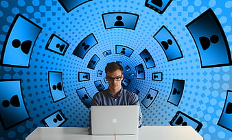 Young man working on laptop with social media icons background