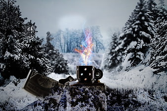 Lighter with colorful flame in snowy winter forest landscape