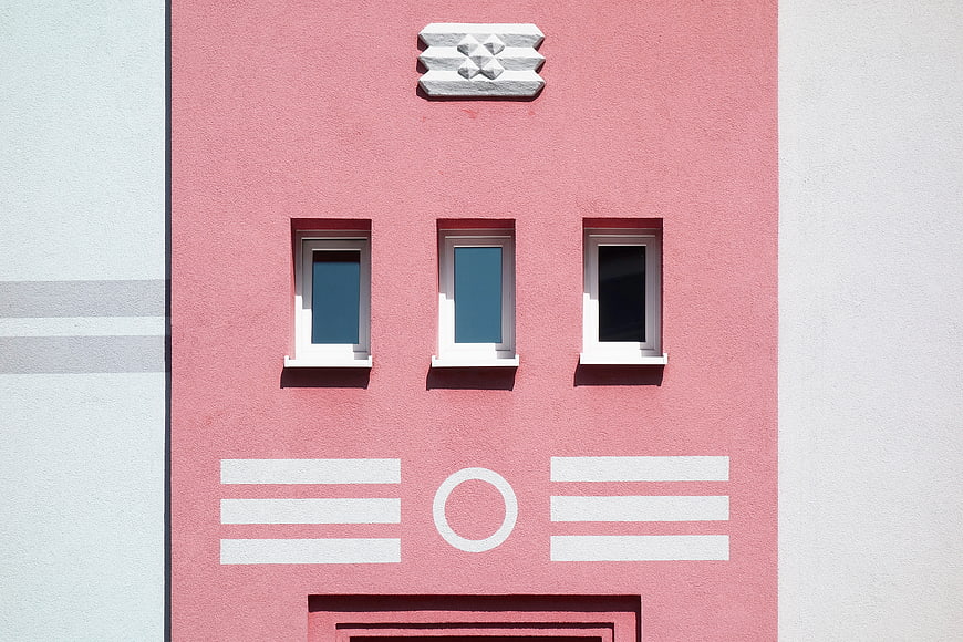 Pink Art Deco Building Facade with Geometric Details