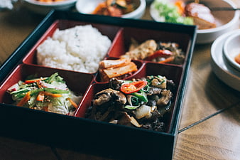 Korean bento box with rice, meat, and vegetables