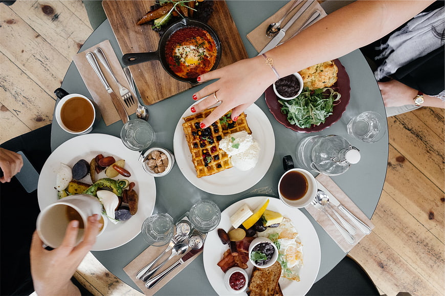 Overhead view of friends sharing a delicious brunch spread