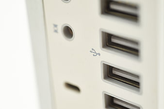 Close-up of white USB ports and audio jack on computer