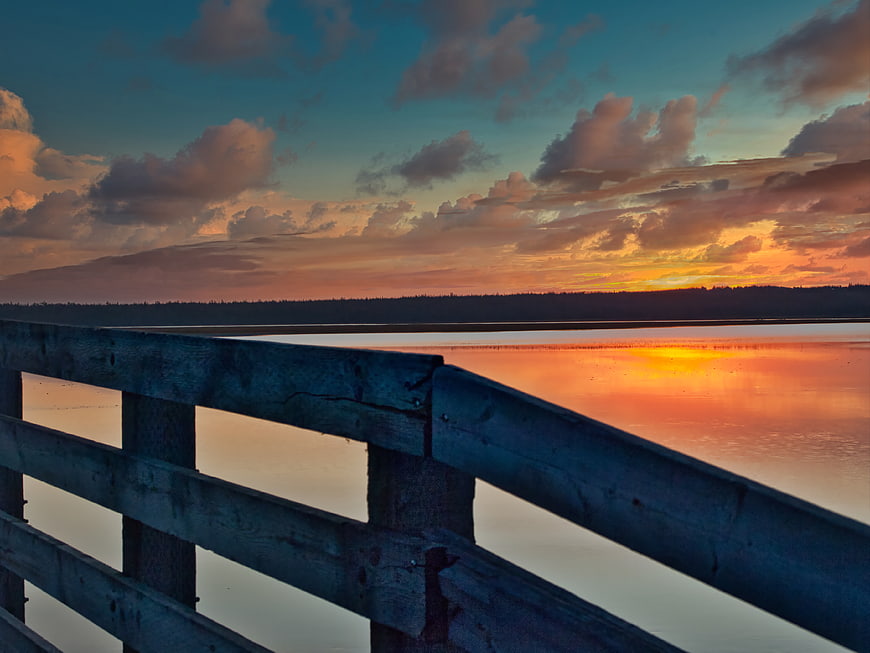 Sunset Reflection on Lake with Wooden Dock Foreground