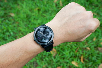 Garmin Smartwatch on Wrist with Green Grass Background