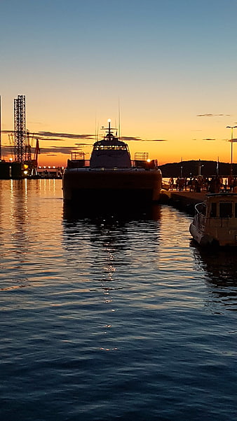 Catamaran Ferry Docked at Harbor During Golden Sunset