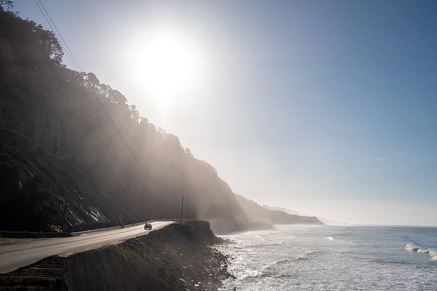 Sunlit Coastal Highway with Cliffs and Ocean