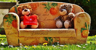 Two teddy bears on citrus print sofa with Mother's Day gift