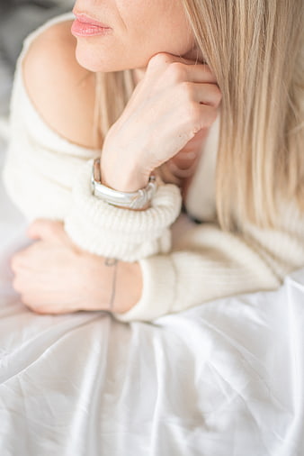 Close-up of Woman in White Sweater Relaxing in Bed