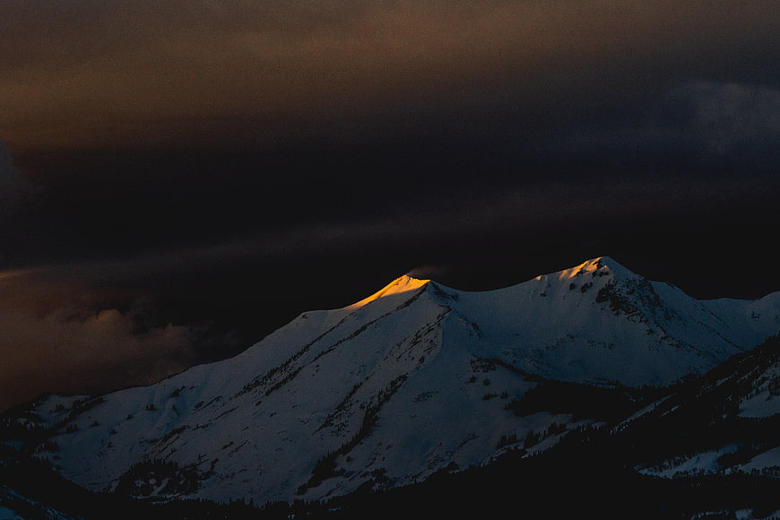 Snowy Mountain Peaks Illuminated by Golden Sunset Light