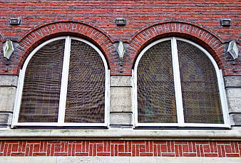 Red brick facade with arched windows and white frames