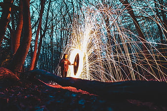 Man Spinning Steel Wool Fire in Forest at Night