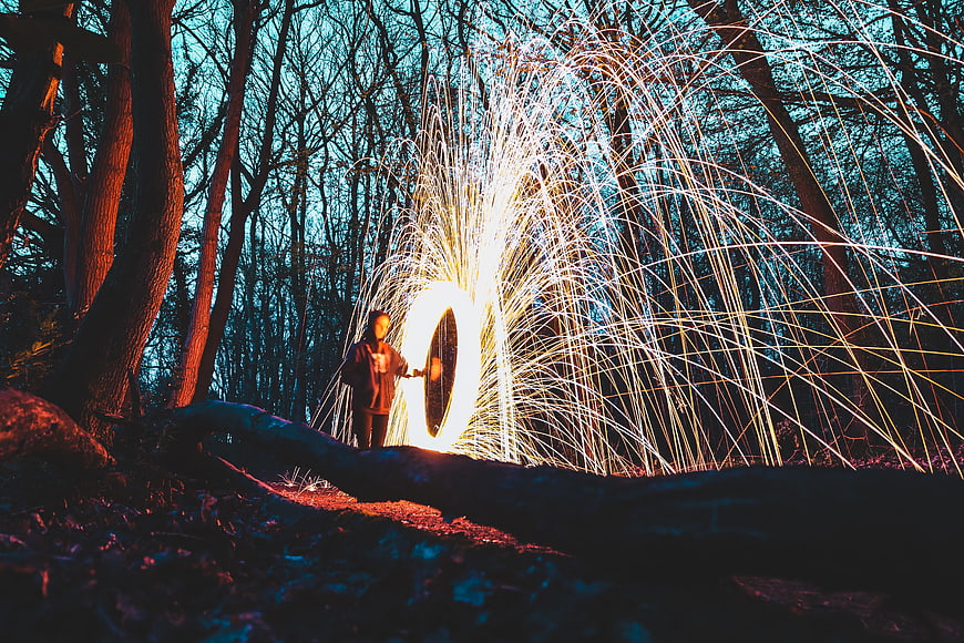 Man Spinning Steel Wool Fire in Forest at Night