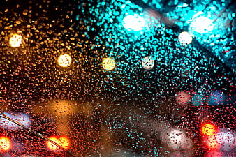 Raindrops on Car Window with City Bokeh Lights