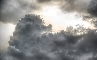 Dramatic storm clouds with bright sunlight breaking through