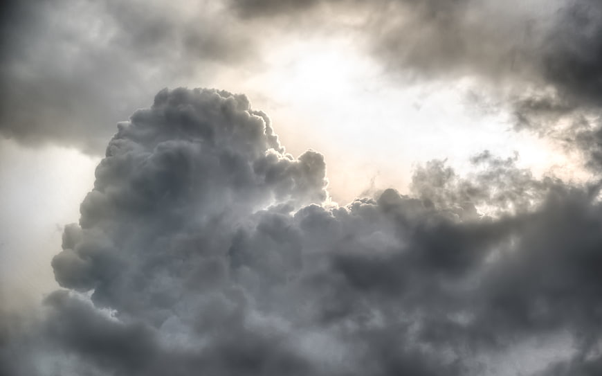 Dramatic storm clouds with bright sunlight breaking through